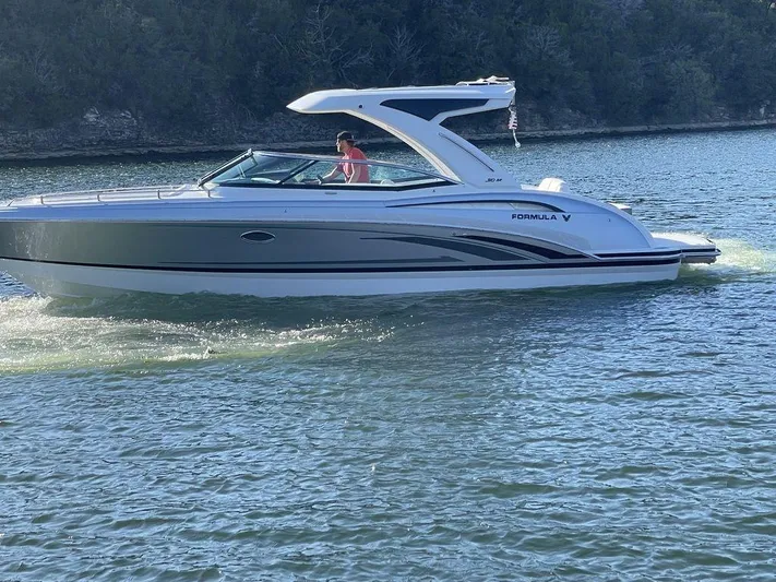 Only A Formula Yacht Photos Pics 2025 Formula 310 Bowrider cruising on a serene lake.