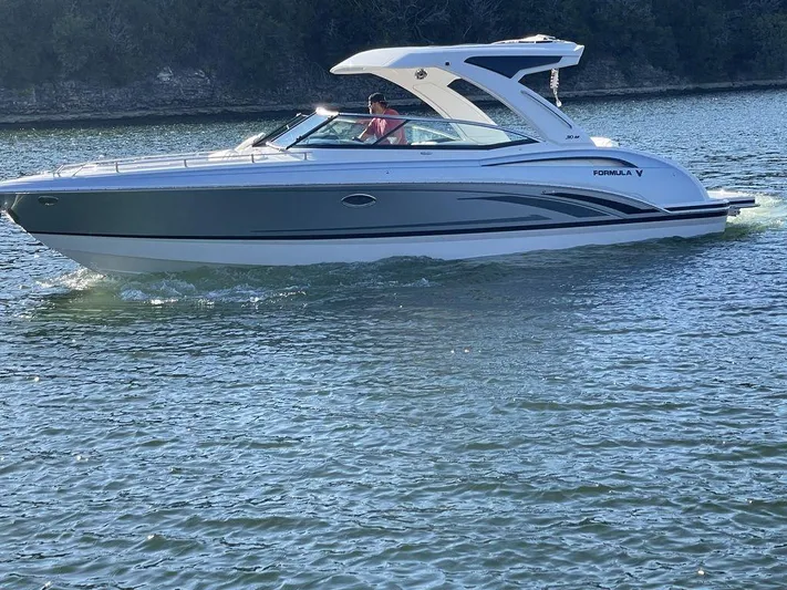 Only A Formula Yacht Photos Pics 2025 Formula 310 Bowrider cruising on a serene lake.