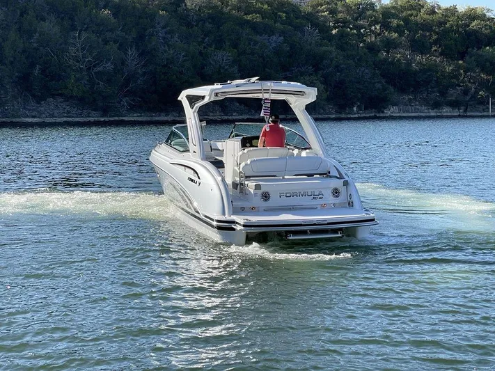 Only A Formula Yacht Photos Pics 2025 Formula 310 Bowrider cruising on a serene lake with lush forest backdrop.