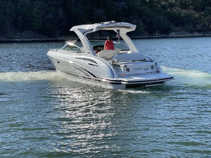 Only A Formula Yacht Photos Pics 2025 Formula 310 Bowrider cruising on a serene lake with lush forest backdrop.