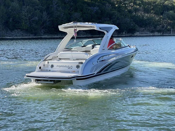 Only A Formula Yacht Photos Pics 2025 Formula 310 Bowrider cruising on a serene lake, showcasing sleek design and luxury.