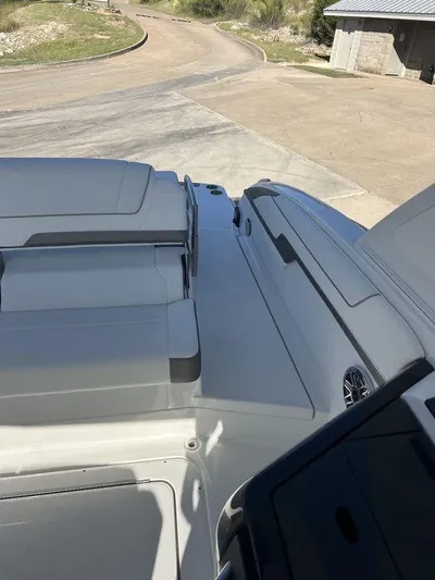 Only A Formula Yacht Photos Pics 2025 Formula 310 Bowrider boat, rear deck view, parked on a concrete surface.