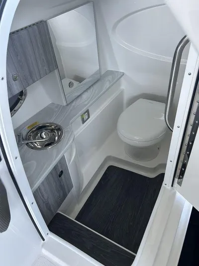 Only A Formula Yacht Photos Pics 2025 Formula 310 Bowrider bathroom with modern sink, toilet, and sleek design.