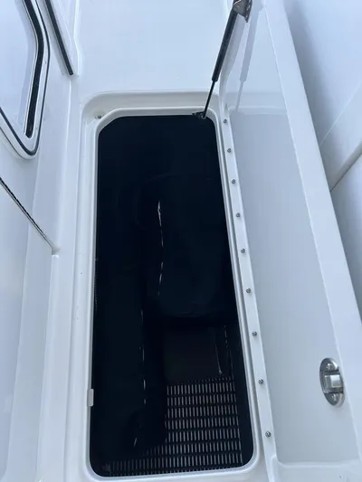 Only A Formula Yacht Photos Pics 2025 Formula 310 Bowrider storage compartment with open hatch and hydraulic lift.