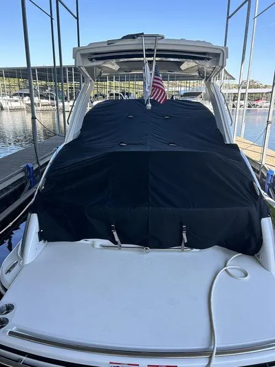 Only A Formula Yacht Photos Pics 2025 Formula 310 Bowrider docked, covered with a black tarp, American flag displayed.