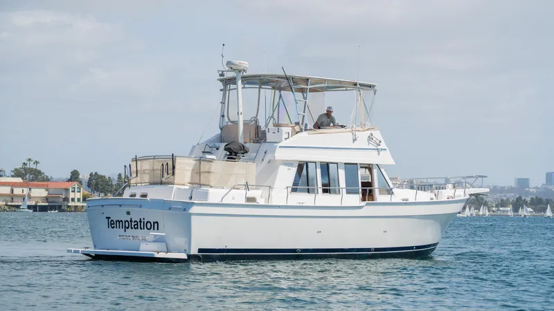 Temptation Yacht Photos Pics 2005 Mainship 43 Trawler Aft Cabin cruising on calm waters.
