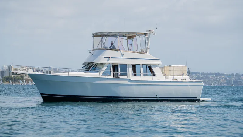 Temptation Yacht Photos Pics 2005 Mainship 43 Trawler Aft Cabin cruising on calm waters.