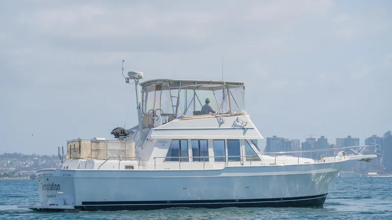 Temptation Yacht Photos Pics 2005 Mainship 43 Trawler Aft Cabin cruising on calm waters.