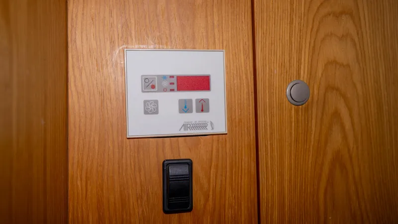 Temptation Yacht Photos Pics Control panel on 2005 Mainship 43 Trawler Aft Cabin wooden interior.