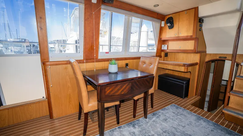 Temptation Yacht Photos Pics 2005 Mainship 43 Trawler Aft Cabin interior with dining area and wooden furnishings.