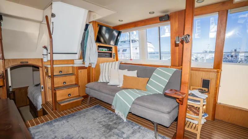 Temptation Yacht Photos Pics 2005 Mainship 43 Trawler Aft Cabin interior with cozy seating and nautical decor.