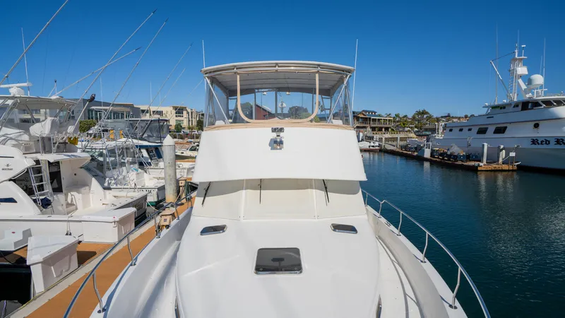 Temptation Yacht Photos Pics 2005 Mainship 43 Trawler Aft Cabin docked in a marina under clear blue skies.