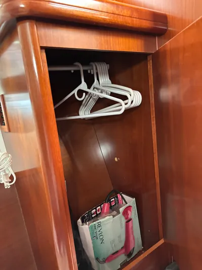 Windsome Yacht Photos Pics Wooden closet in 2006 Beneteau Oceanis 373 yacht with hangers and a Revlon hairdryer.
