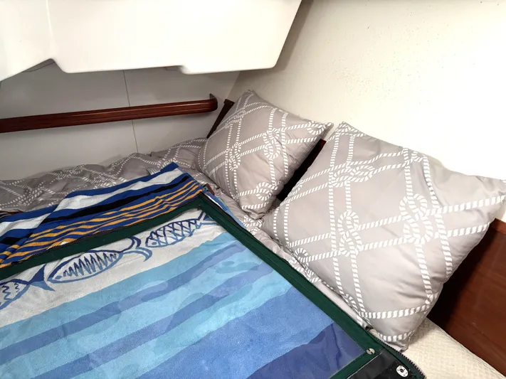 Windsome Yacht Photos Pics Cozy cabin interior of 2006 Beneteau Oceanis 373 with nautical-themed bedding and pillows.