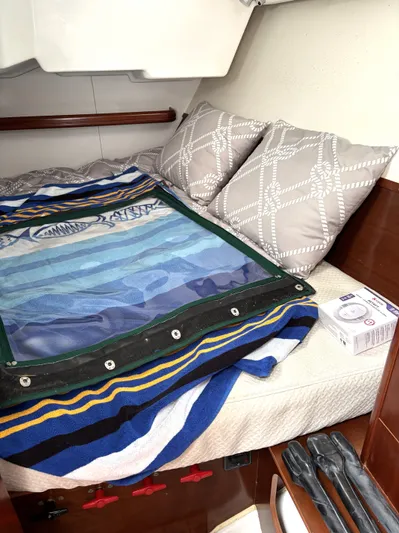 Windsome Yacht Photos Pics Cozy cabin interior of 2006 Beneteau Oceanis 373 sailboat with colorful bedding and pillows.