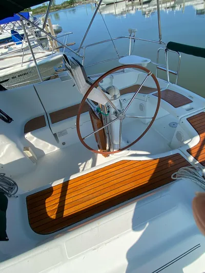 Windsome Yacht Photos Pics 2006 Beneteau Oceanis 373 sailboat cockpit with wooden accents and steering wheel.