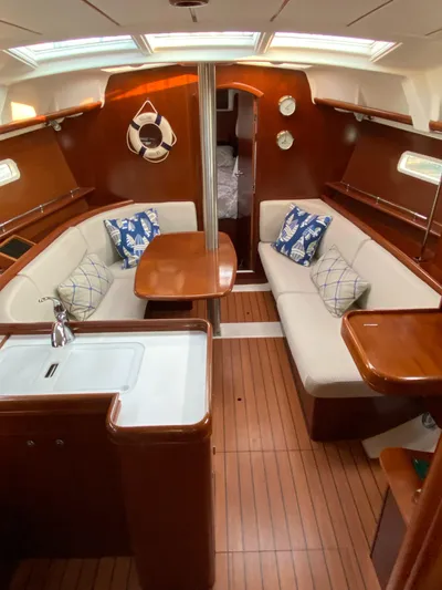 Windsome Yacht Photos Pics Interior of 2006 Beneteau Oceanis 373 sailboat with cozy seating and wooden finishes.