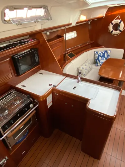 Windsome Yacht Photos Pics Interior of 2006 Beneteau Oceanis 373 yacht with kitchen and seating area.