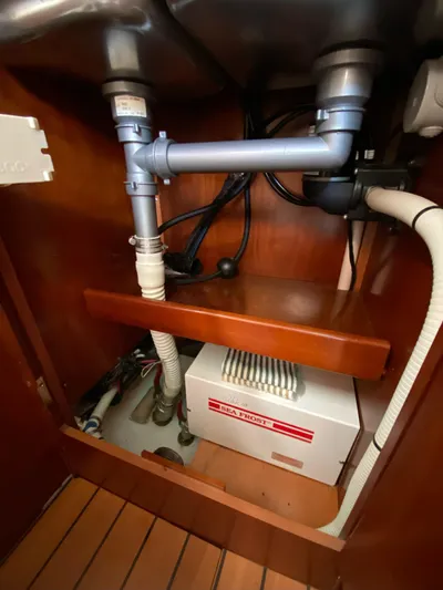 Windsome Yacht Photos Pics Under-sink plumbing and Sea Frost unit in 2006 Beneteau Oceanis 373 yacht.
