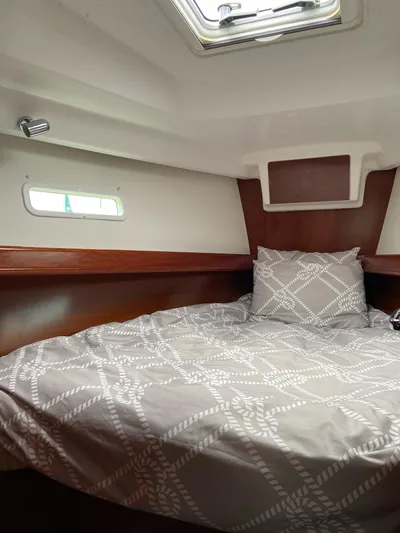 Windsome Yacht Photos Pics Cozy cabin interior of 2006 Beneteau Oceanis 373 sailboat with patterned bedding.