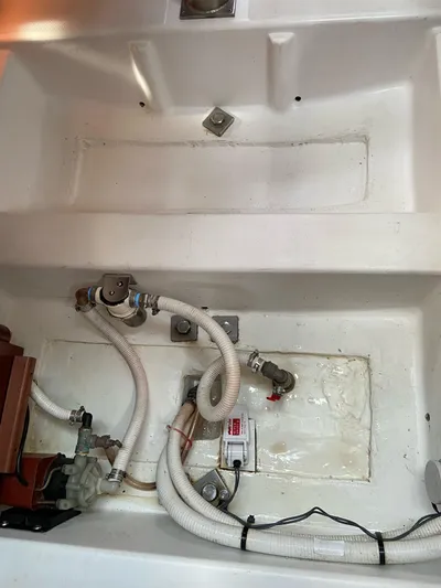 Windsome Yacht Photos Pics Bilge area of a 2006 Beneteau Oceanis 373 sailboat with visible plumbing and fittings.