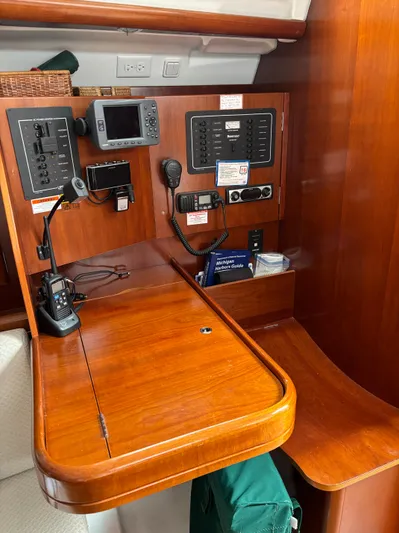 Windsome Yacht Photos Pics Navigation station of a 2006 Beneteau Oceanis 373 sailboat with communication equipment.