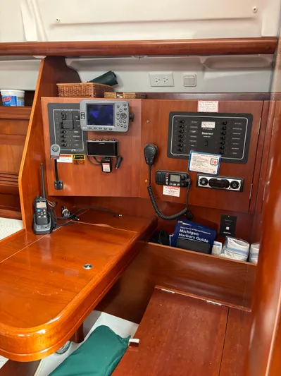 Windsome Yacht Photos Pics Navigation station on a 2006 Beneteau Oceanis 373 sailboat with control panels and communication equipment.