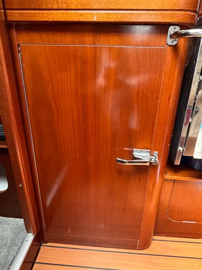 Windsome Yacht Photos Pics Wooden cabinet door inside a 2006 Beneteau Oceanis 373 sailboat interior.