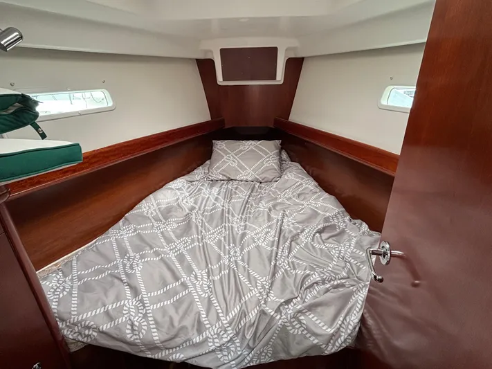 Windsome Yacht Photos Pics Cozy cabin interior of 2006 Beneteau Oceanis 373 sailboat with patterned bedding.