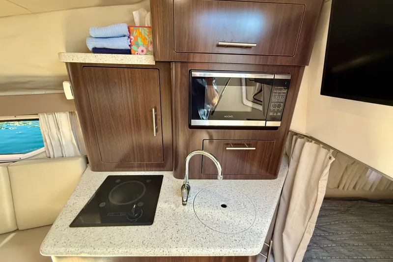 My Particular Harbor Yacht Photos Pics Interior of 2018 Regal 28 Express with kitchenette and microwave.