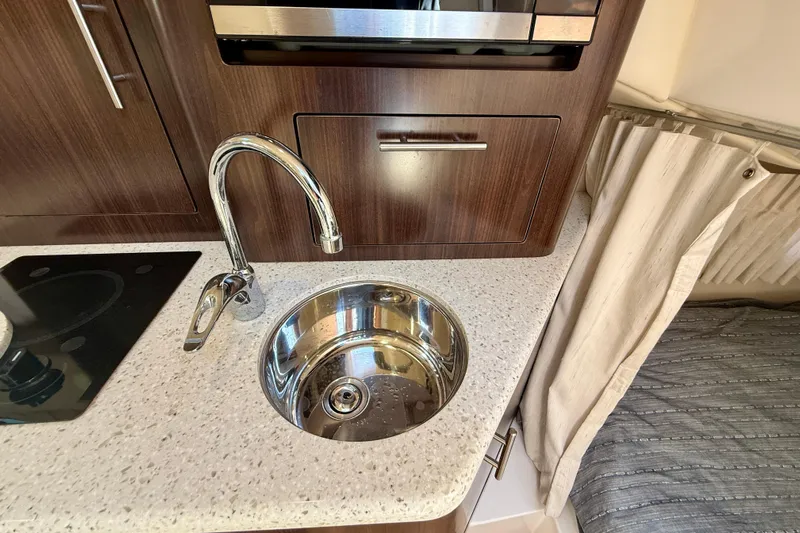 My Particular Harbor Yacht Photos Pics Compact kitchen area in 2018 Regal 28 Express boat with sink and countertop.