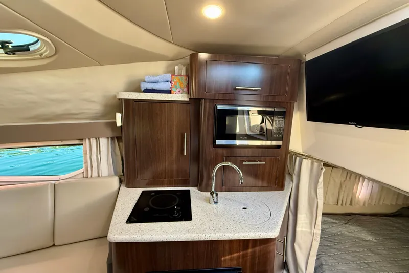 My Particular Harbor Yacht Photos Pics Interior of 2018 Regal 28 Express boat featuring kitchenette with microwave and sink.