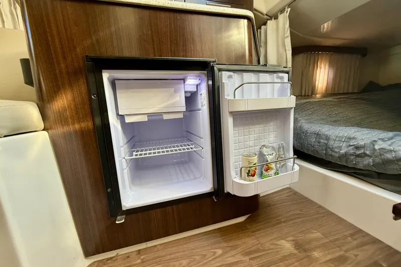 My Particular Harbor Yacht Photos Pics Compact fridge in 2018 Regal 28 Express boat cabin, with drinks stored inside.