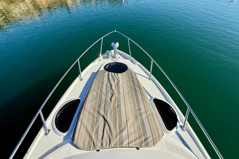 My Particular Harbor Yacht Photos Pics Bow view of 2018 Regal 28 Express boat on calm water.