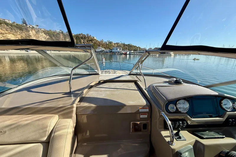 My Particular Harbor Yacht Photos Pics 2018 Regal 28 Express boat interior with dashboard, overlooking serene waters and coastal scenery.