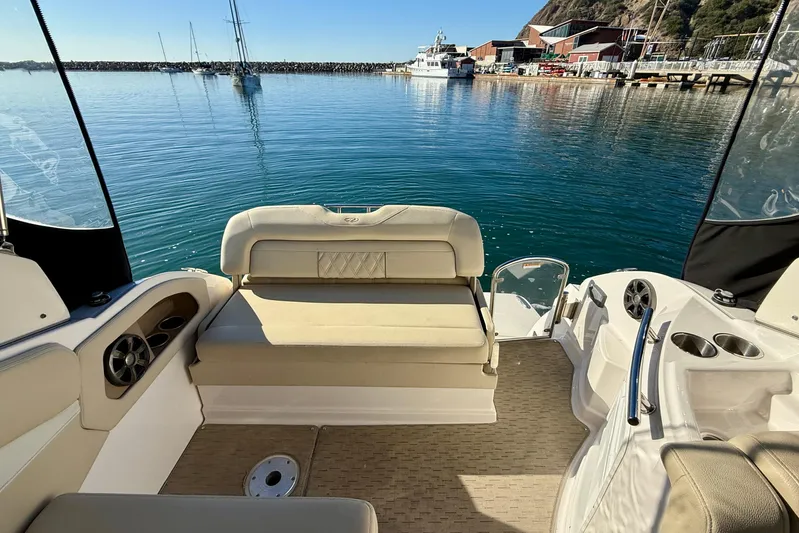 My Particular Harbor Yacht Photos Pics 2018 Regal 28 Express boat interior with seating, docked in a serene marina.