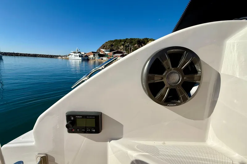 My Particular Harbor Yacht Photos Pics 2018 Regal 28 Express boat interior with speaker and control panel, docked in a serene harbor.