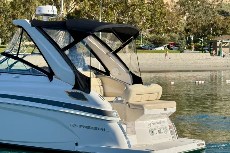 My Particular Harbor Yacht Photos Pics 2018 Regal 28 Express boat docked near a scenic beach.