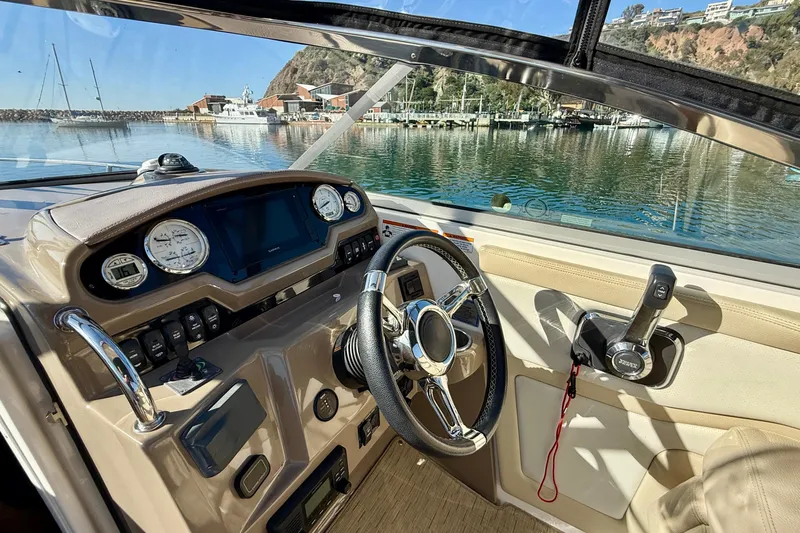 My Particular Harbor Yacht Photos Pics Cockpit view of 2018 Regal 28 Express boat with steering wheel and controls.