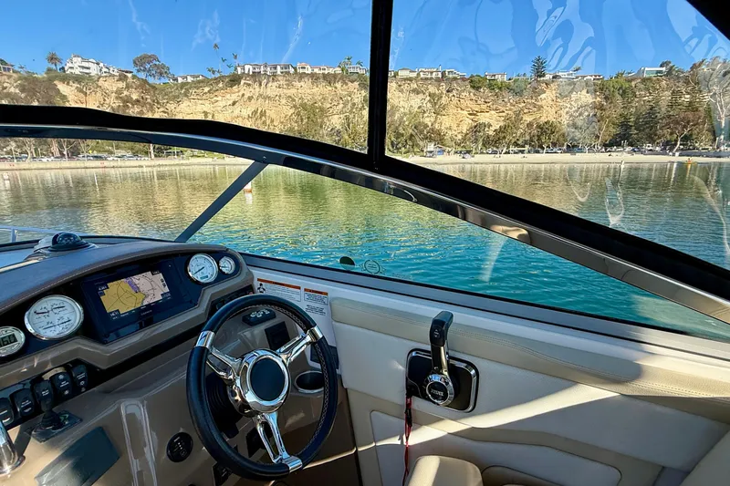 My Particular Harbor Yacht Photos Pics Cockpit view of 2018 Regal 28 Express boat with scenic waterfront background.