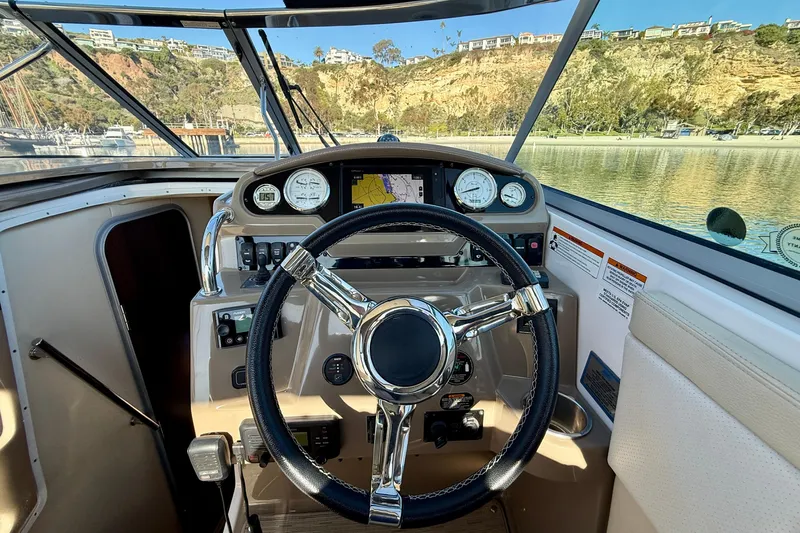 My Particular Harbor Yacht Photos Pics Cockpit view of 2018 Regal 28 Express boat with steering wheel and dashboard controls.