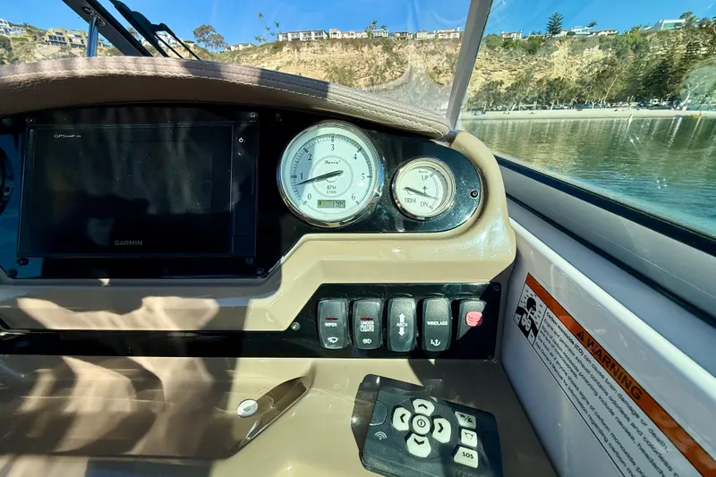 My Particular Harbor Yacht Photos Pics 2018 Regal 28 Express boat dashboard with gauges and controls, scenic background.