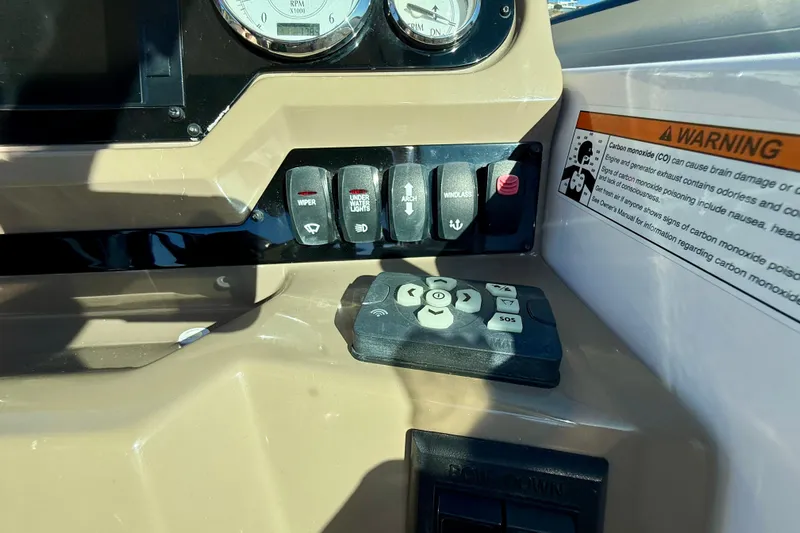 My Particular Harbor Yacht Photos Pics Control panel of a 2018 Regal 28 Express boat with warning label and switches.