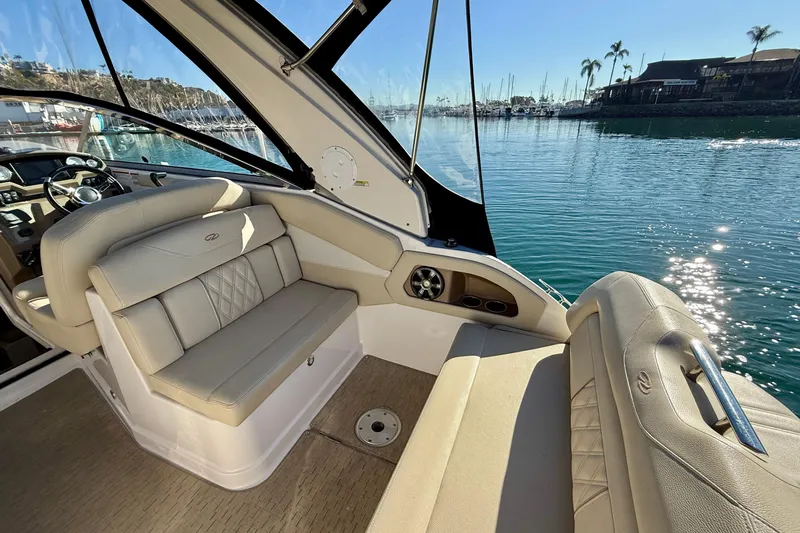 My Particular Harbor Yacht Photos Pics 2018 Regal 28 Express boat interior with beige seating, docked in a sunny marina.