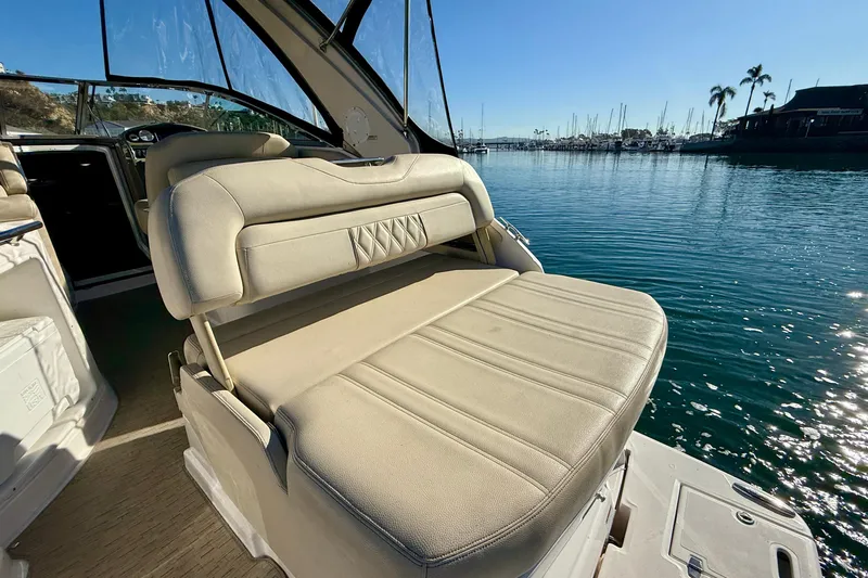 My Particular Harbor Yacht Photos Pics 2018 Regal 28 Express boat interior with beige seating, docked in a sunny marina.