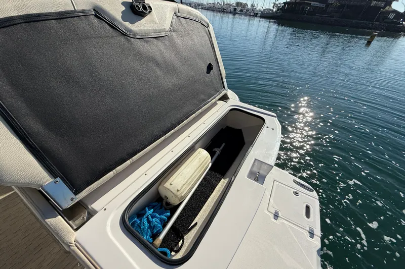 My Particular Harbor Yacht Photos Pics Open storage compartment on 2018 Regal 28 Express boat by the water.