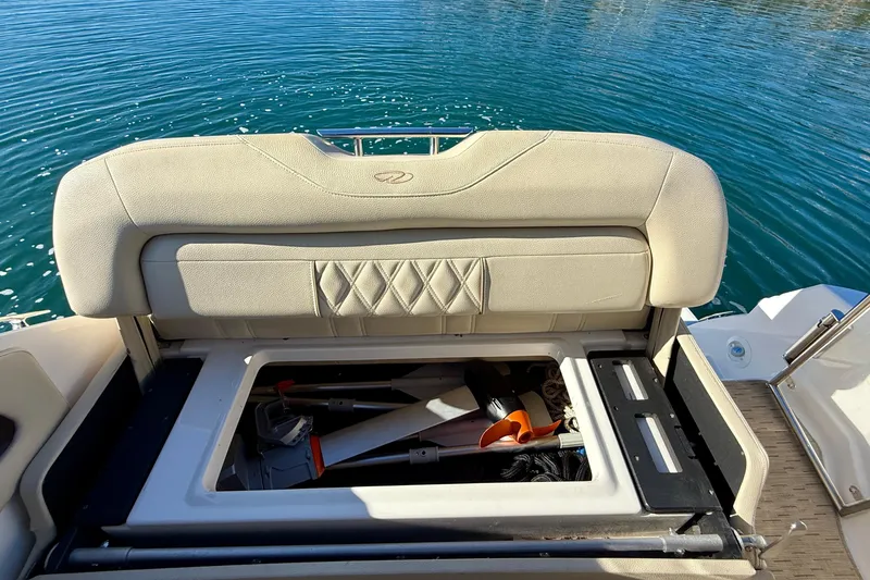 My Particular Harbor Yacht Photos Pics 2018 Regal 28 Express boat storage compartment with open seat, revealing equipment inside.