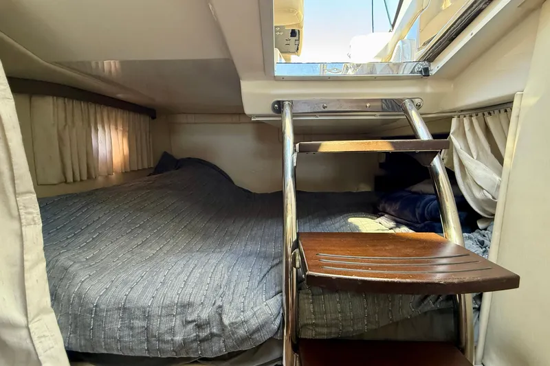 My Particular Harbor Yacht Photos Pics 2018 Regal 28 Express cabin interior with bed and wooden steps.