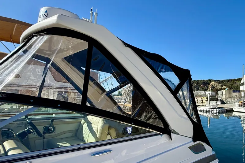 My Particular Harbor Yacht Photos Pics 2018 Regal 28 Express boat with clear canopy, docked under blue sky.