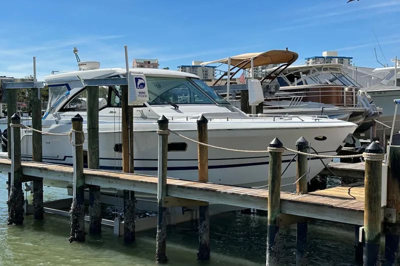  Yacht Photos Pics 2021 Formula 380 Super Sport Crossover OB docked at marina under clear blue sky.